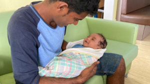 Dad and baby on sofa