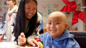 Boy and mother with red ribbon in corner
